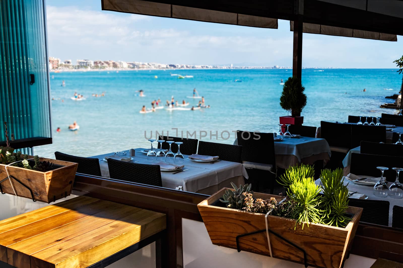 Restaurant on the seashore with the table set. Horizontal image.