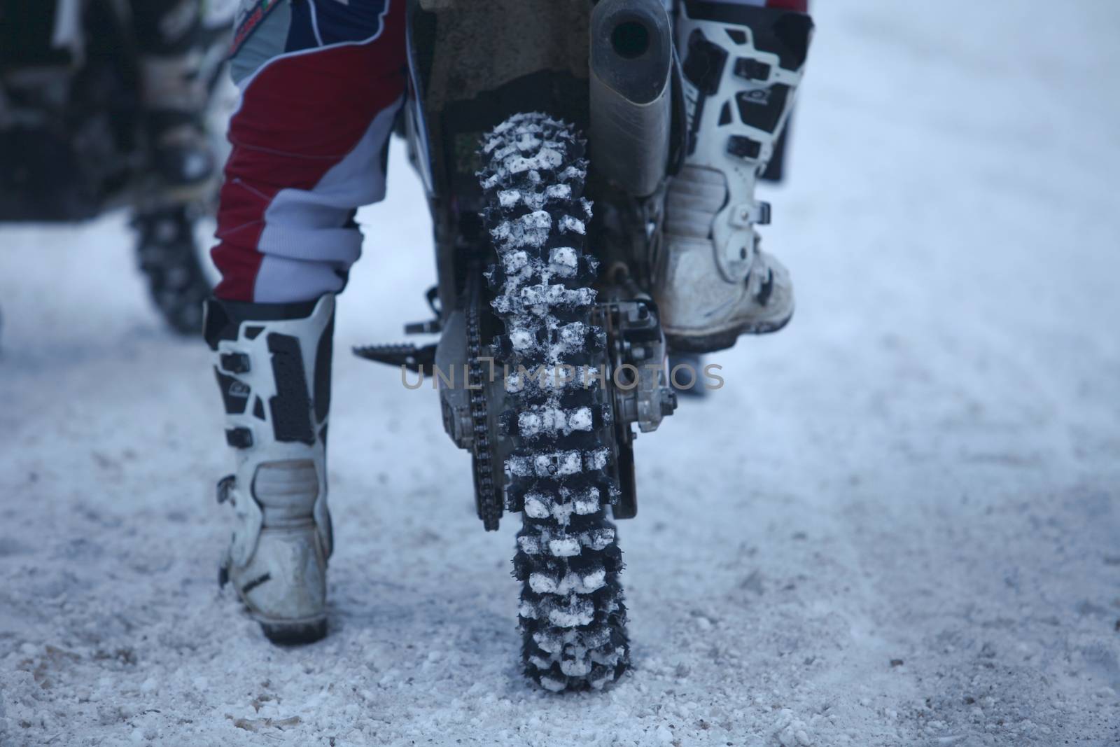 winter motocross racer motorcyclist at the start of the race