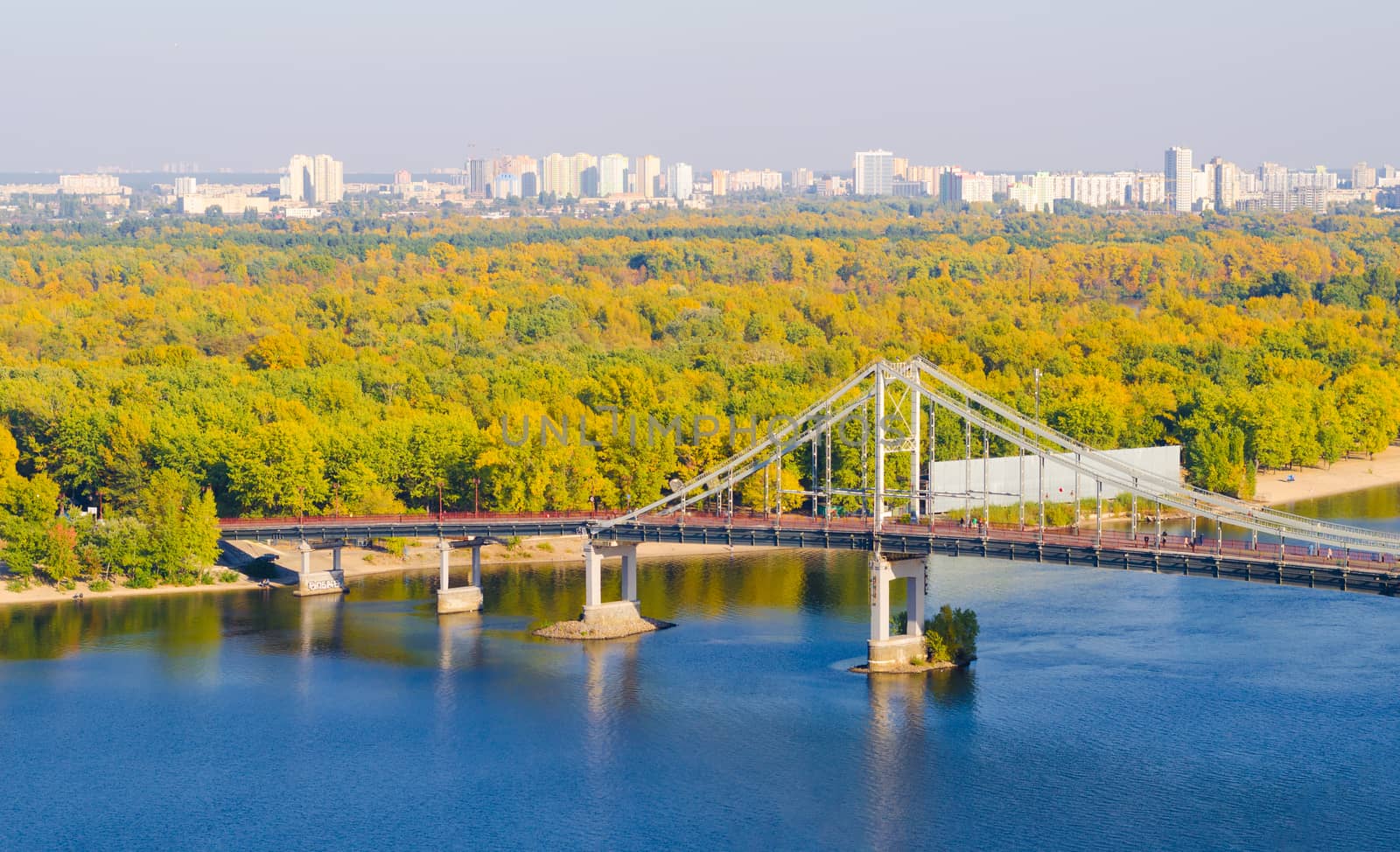 Pedestrian bridge over a cloudy sky Dnieper River in Kiev