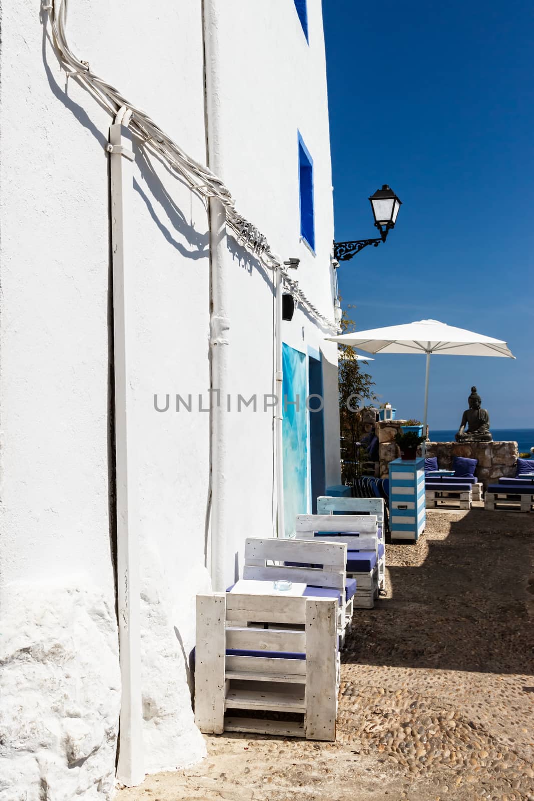 Restaurant with summer terrace and sea views. Vertical image.