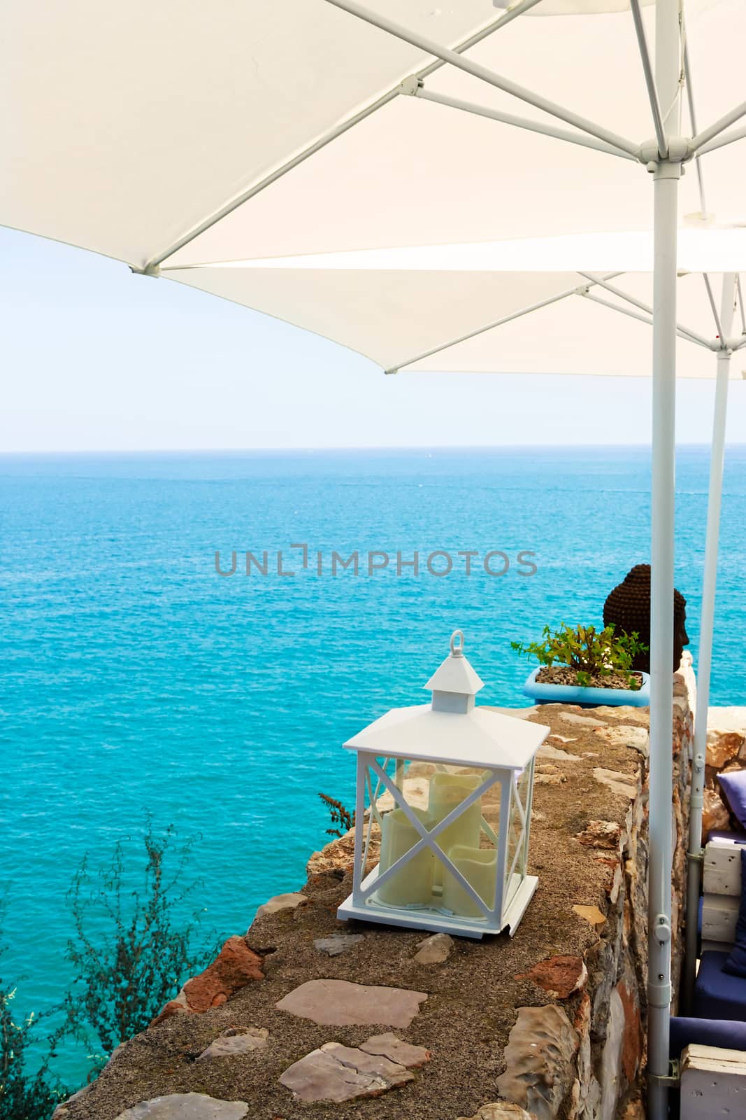 Restaurant with summer terrace and sea views. Vertical image.