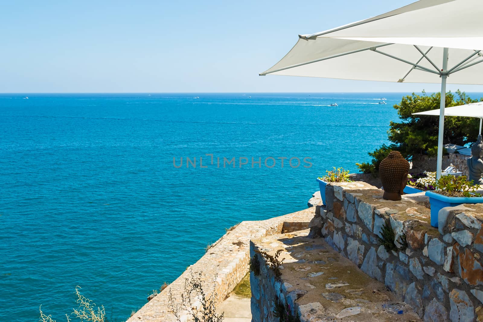 Restaurant with summer terrace and sea views. Horizontal image.