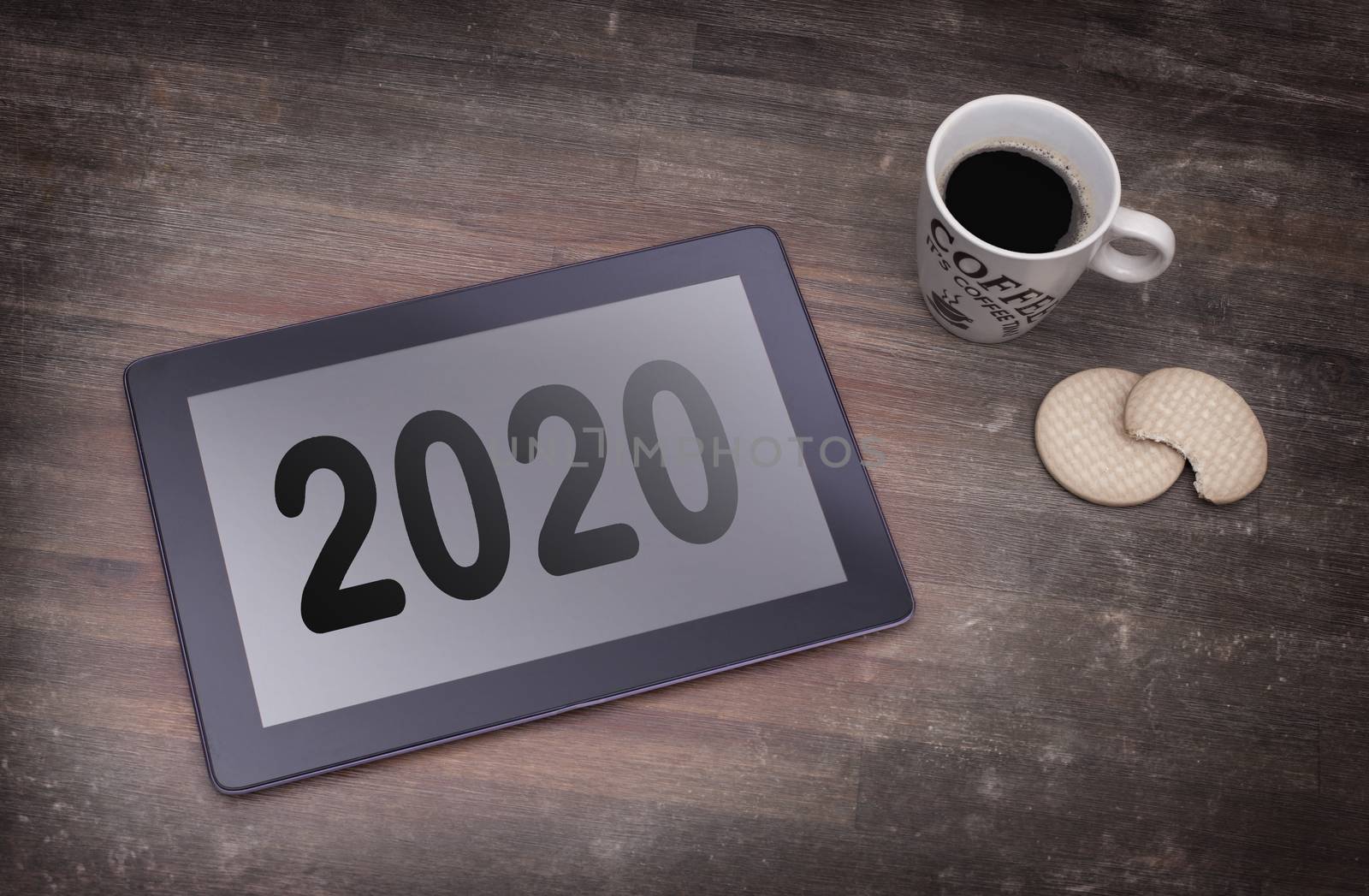 Tablet touch computer gadget on wooden table, vintage look - 2020