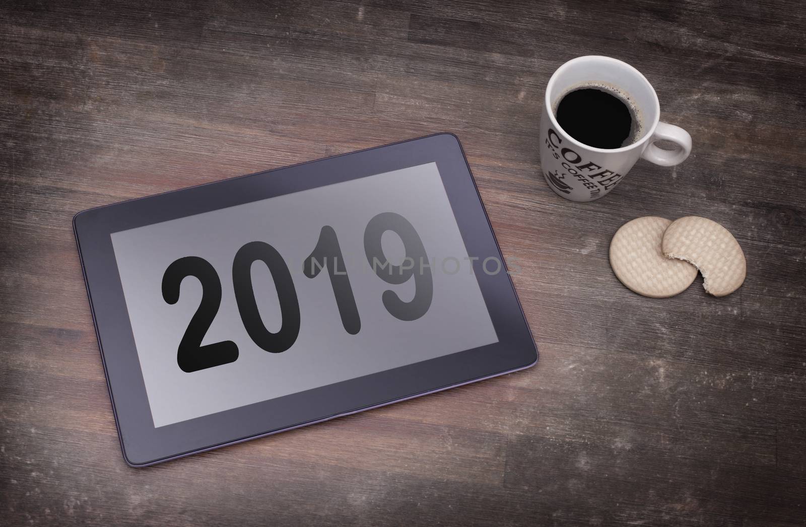 Tablet touch computer gadget on wooden table, vintage look - 2019