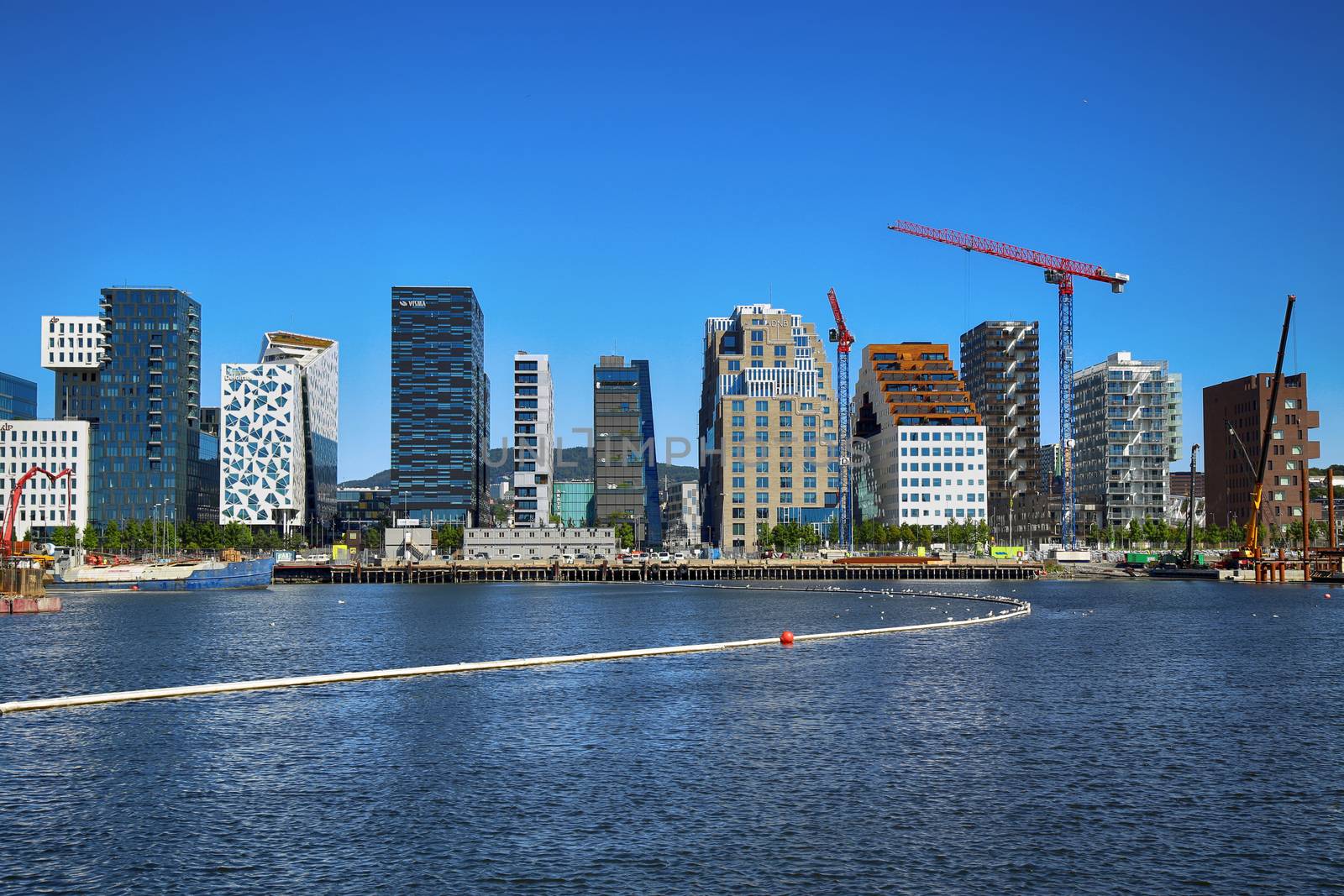 OSLO, NORWAY – AUGUST 17, 2016: A construction site of Bjorvika under construction in progress with a heavy vehicle and cranes in Oslo, Norway on August 17,2016.