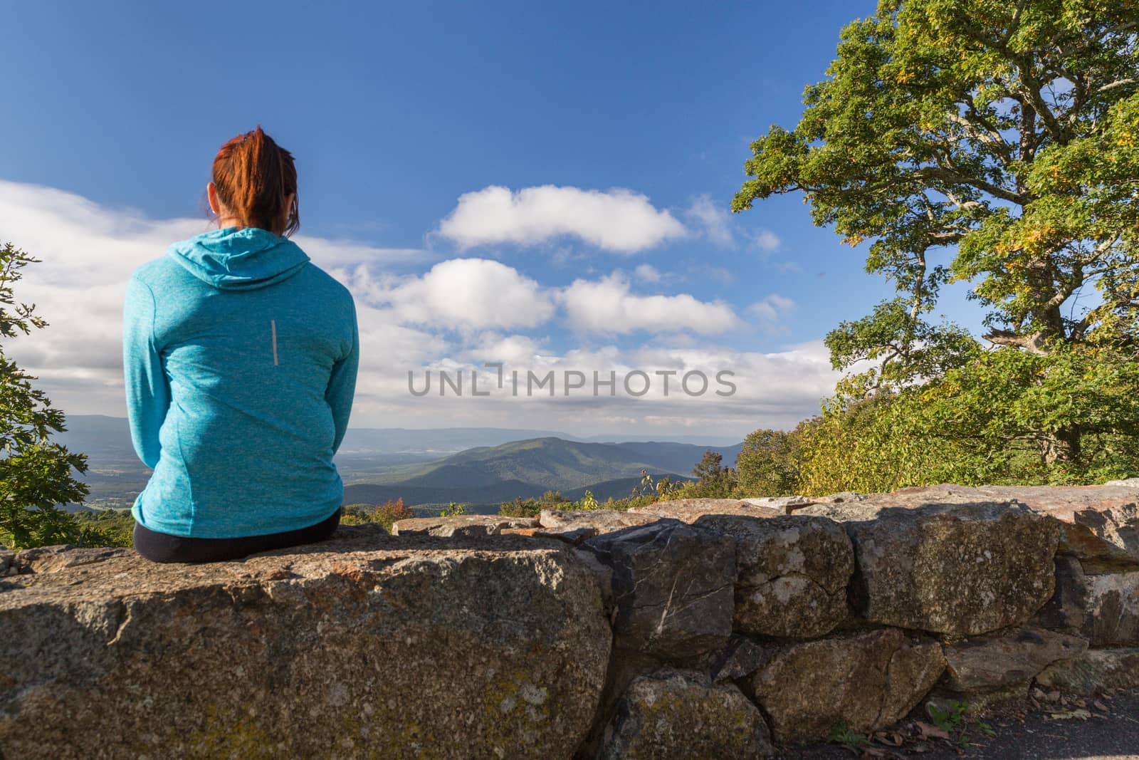 Woman looking down on the Blue Ridge Mountains by chrisukphoto