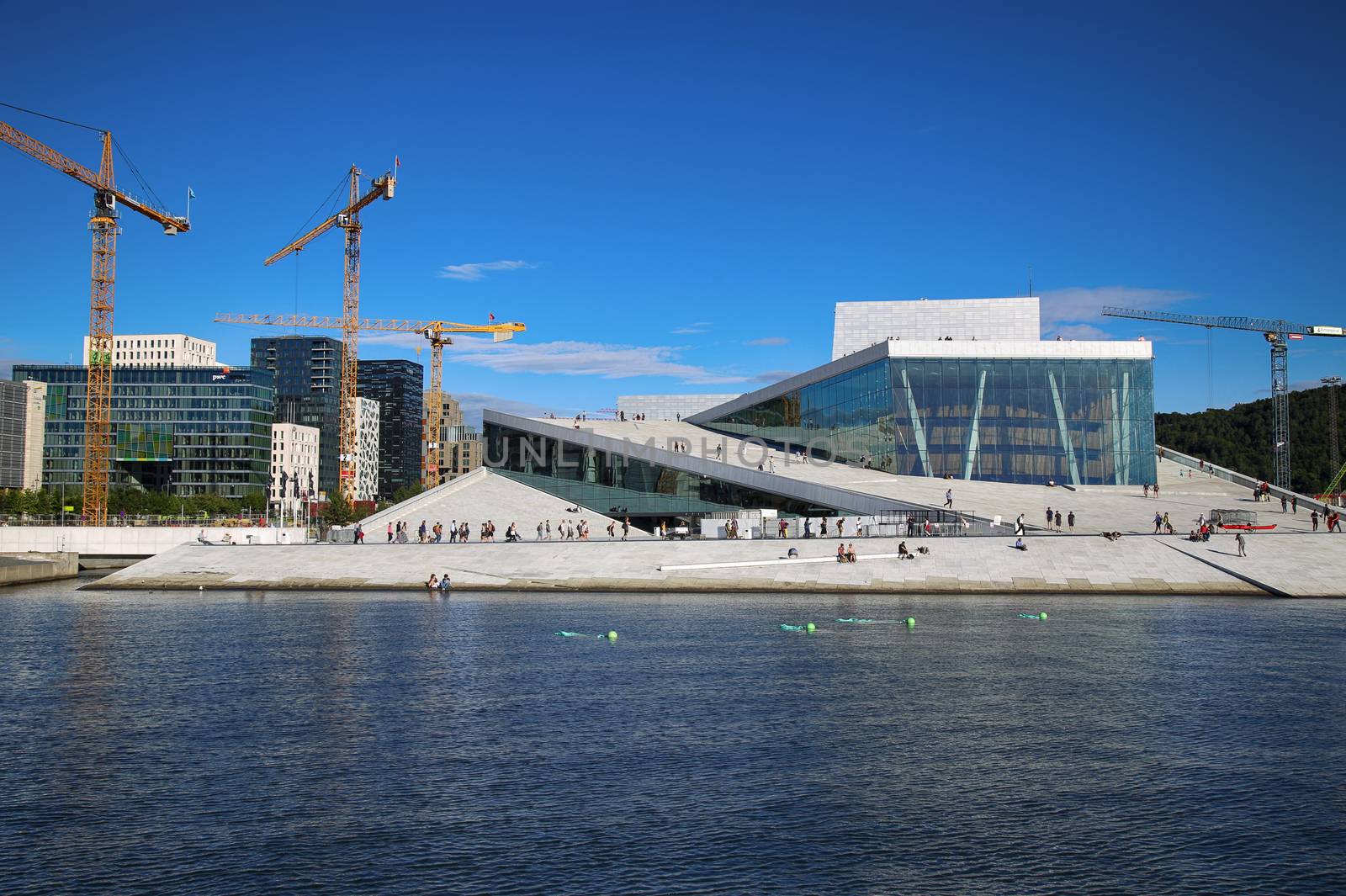 OSLO, NORWAY – AUGUST 17, 2016: Tourist on the Oslo Opera House which is home of Norwegian National Opera and Ballet and National Opera Theatre in Oslo, Norway on August 17,2016.