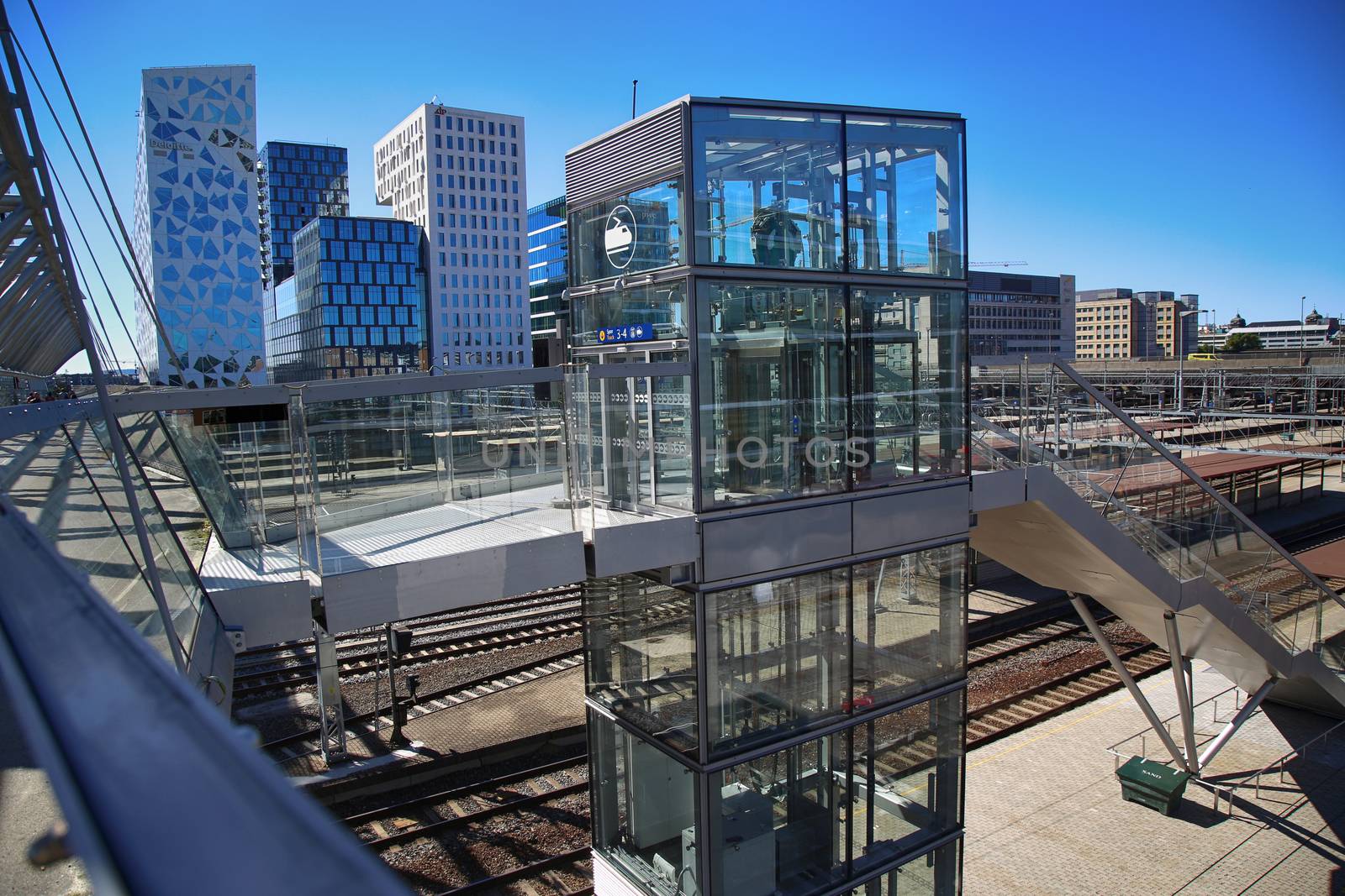 OSLO, NORWAY – AUGUST 17, 2016: View of Akrobaten pedestrian bridge  with modern business architecture and elevator lift that leads to the railway station street in Oslo, Norway on August 17, 2016.