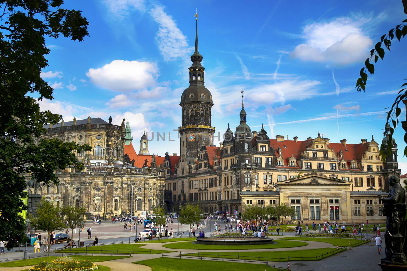 DRESDEN, GERMANY – AUGUST 13, 2016: Tourists walk on Theaterplatz street and majestic view on  Saxony Dresden Castle (Residenzschloss) in Dresden, State of Saxony, Germany on August 13, 2016.