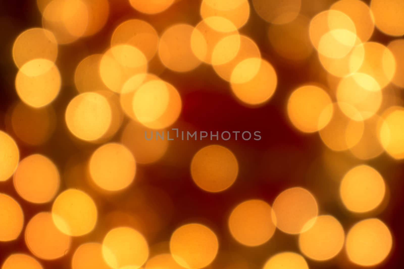 Christmas lights gold blurred lights on red background.