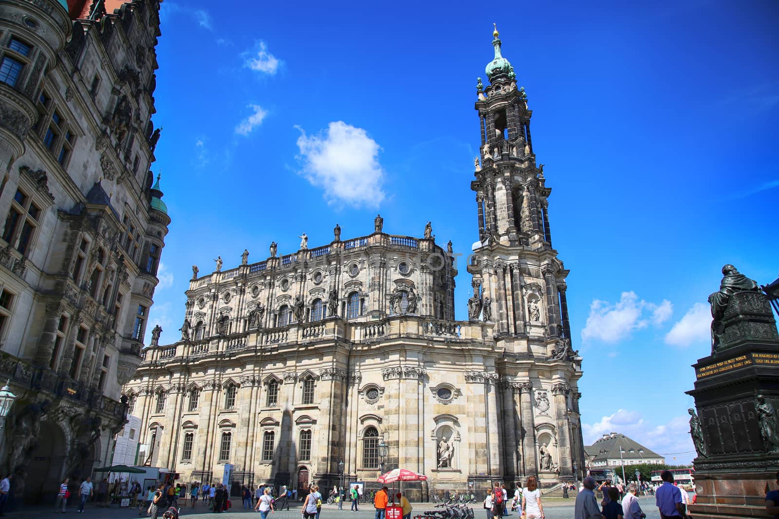 DRESDEN, GERMANY – AUGUST 13, 2016: Tourists walk and visit on Schlossplatz, majestic view on Katholische Hofkirche in Dresden, State of Saxony, Germany on August 13, 2016.