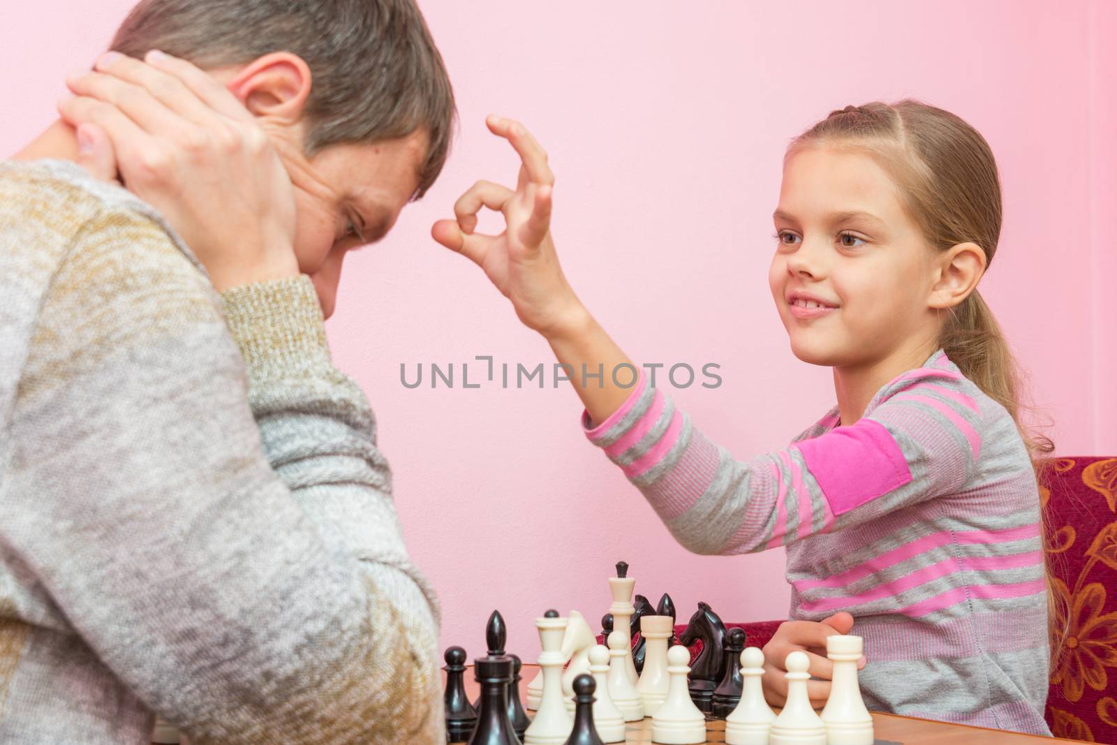 My daughter has a finger on the pope's head, who lost a game of chess