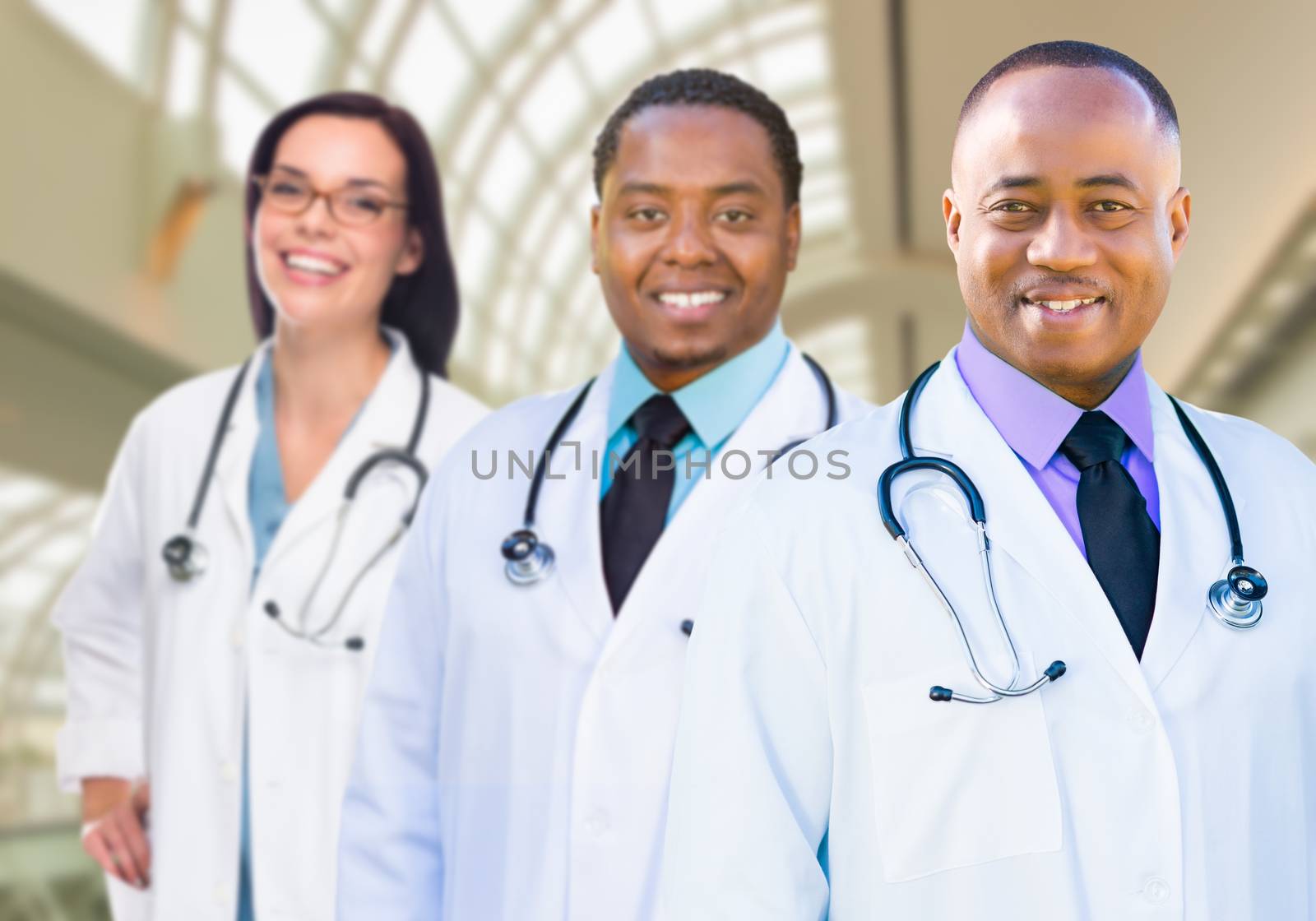 Female and Male Caucasian and African American Doctors in Hospit by Feverpitched
