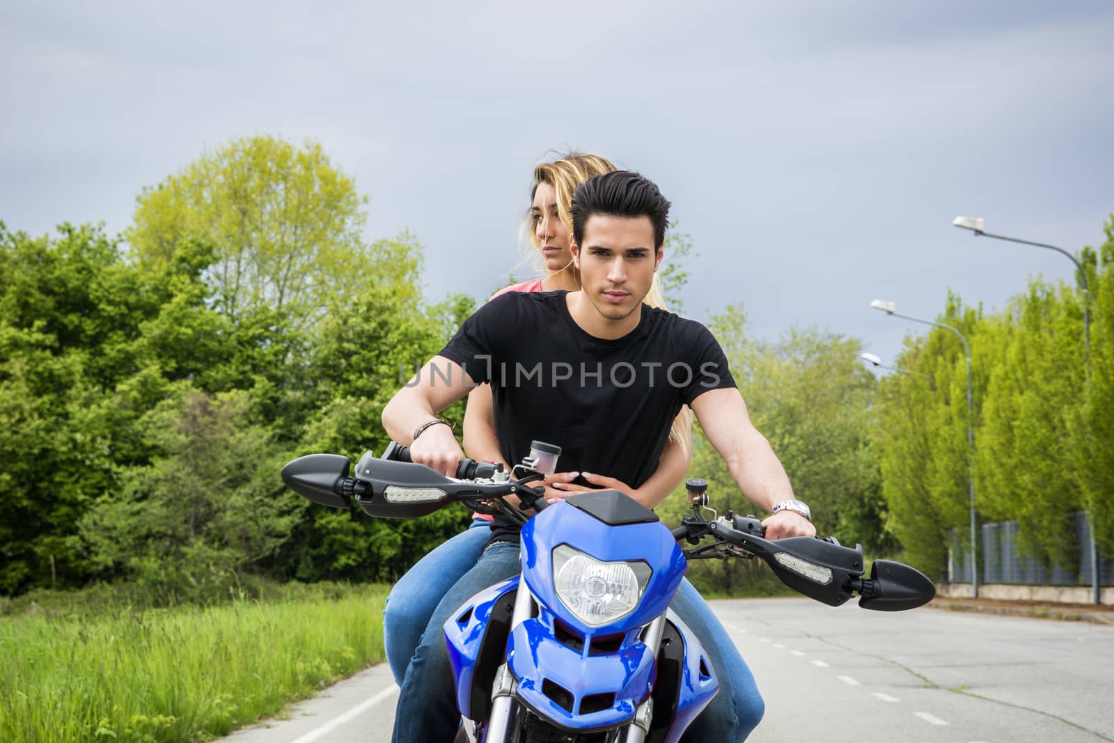 Man and woman riding motorcycle by artofphoto