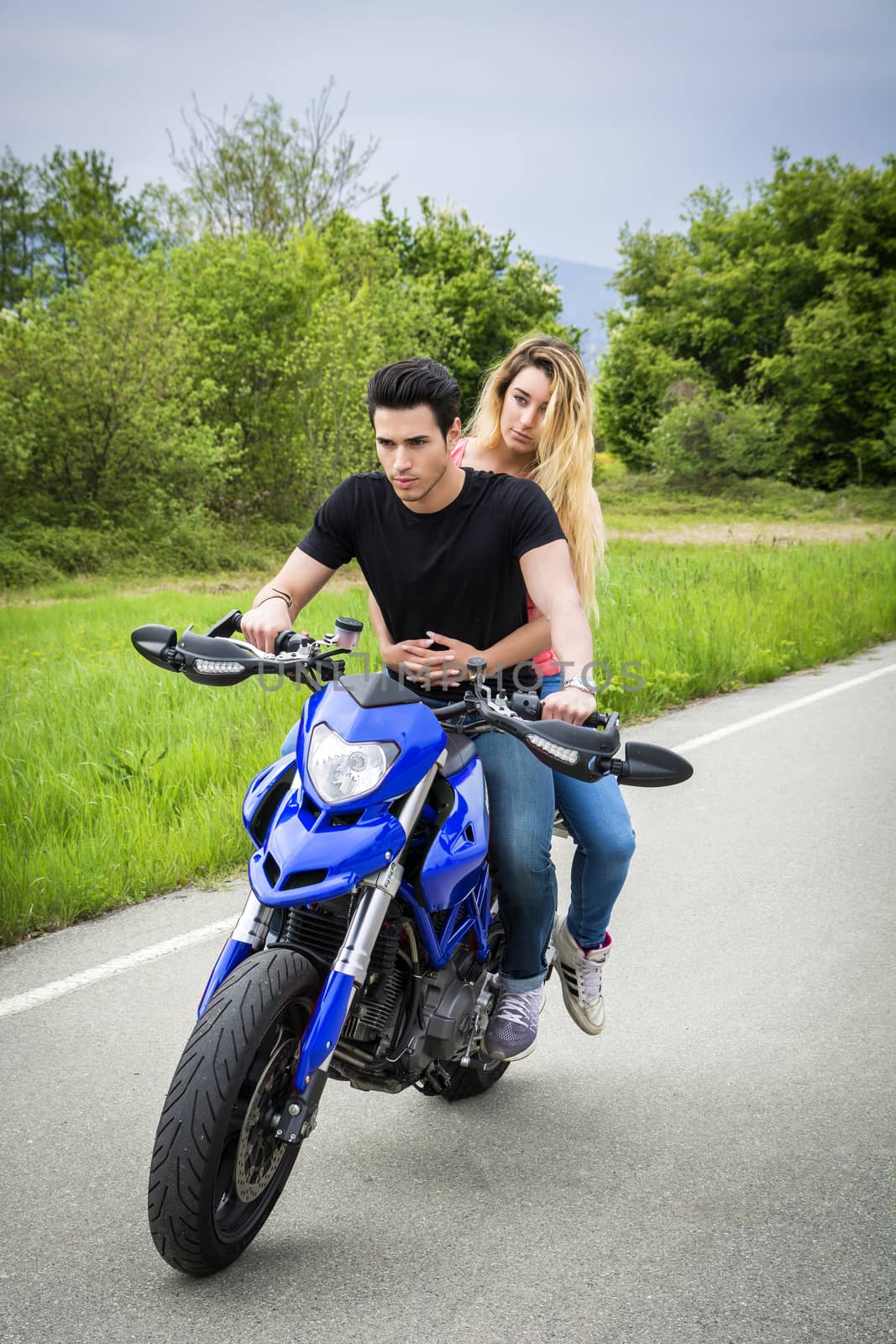 Man and woman riding motorcycle by artofphoto