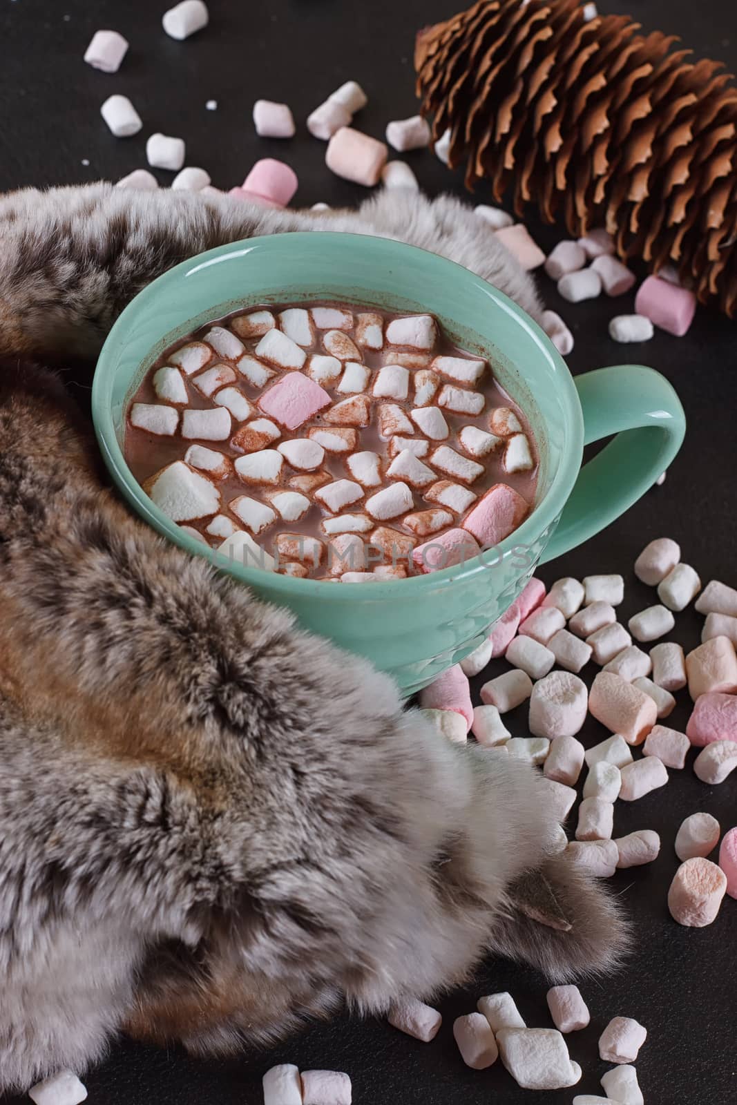 Hot chocolate with marshmallows and fur around.