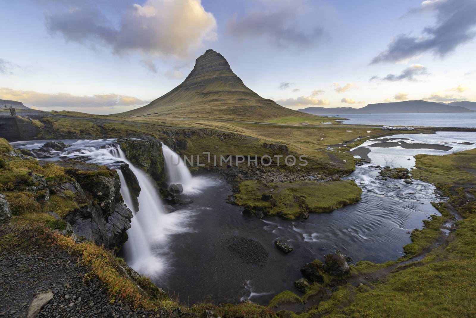 Kirkjufellsfoss Waterfall is located in West Iceland, close to Kirkjufell Mountain and Grundarfjörður Town (Grundarfjordur) on the Snæfellsnes Peninsula