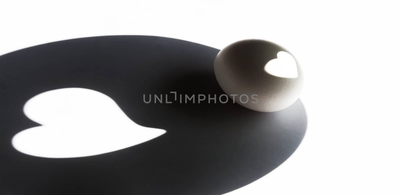 shadow of the eggs and the projection on his heart, abstract, black and white.