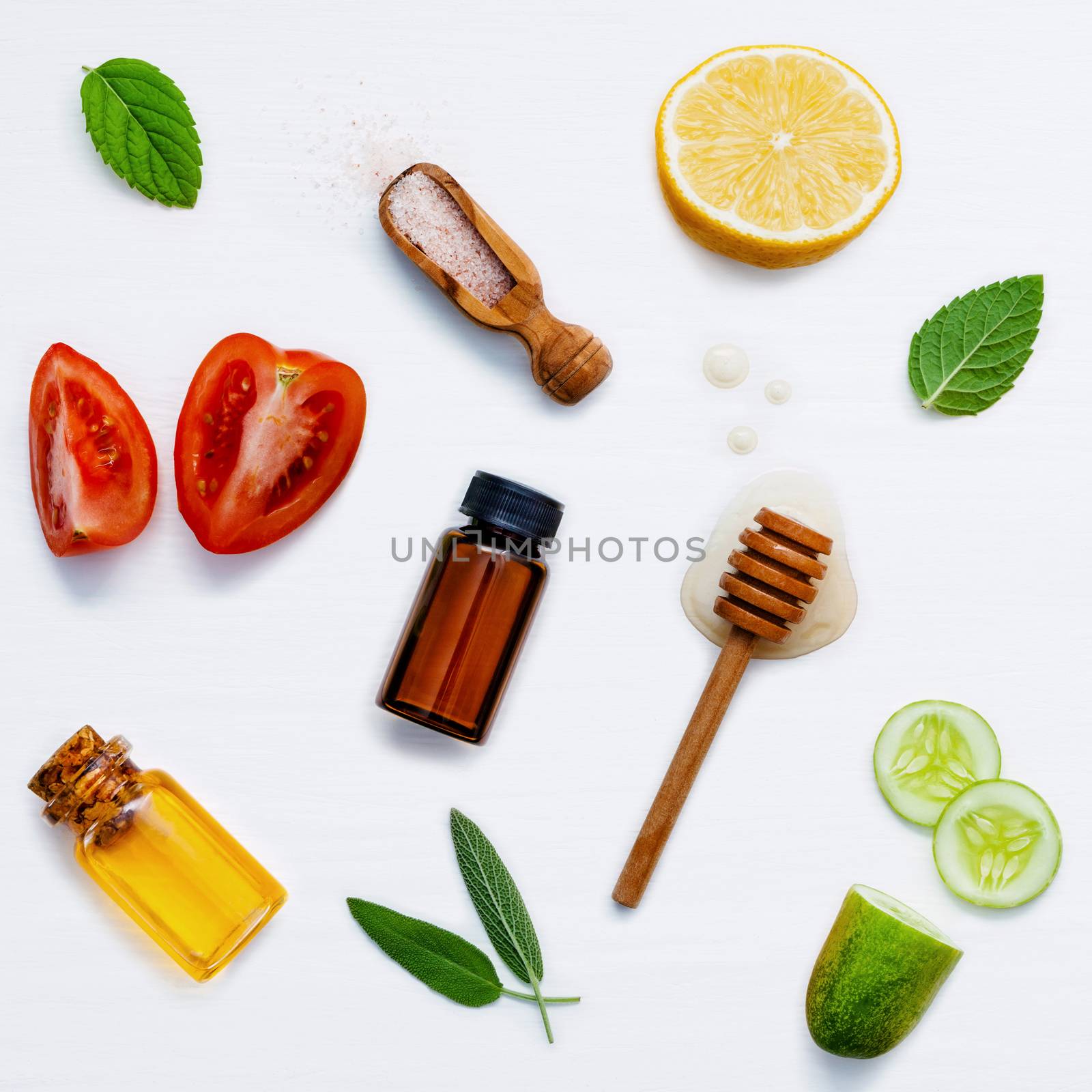 Homemade skin care and body scrubs with natural ingredients aloe vera ,lemon,cucumber ,himalayan salt ,tomato,mint and honey set up on white wooden background with flat lay.
