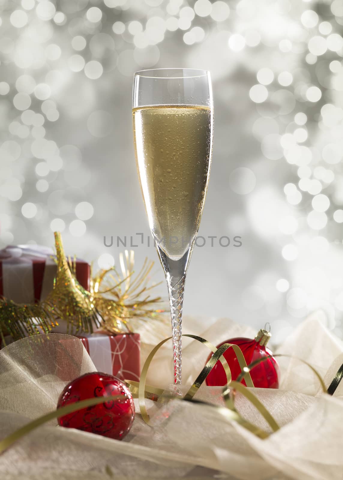 Luxury champagne glass, gift and decoration on an abstract grey  by janssenkruseproductions