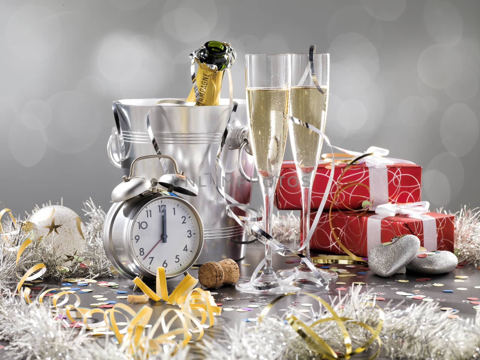 New Year composition with champagne and gifts on a silver background