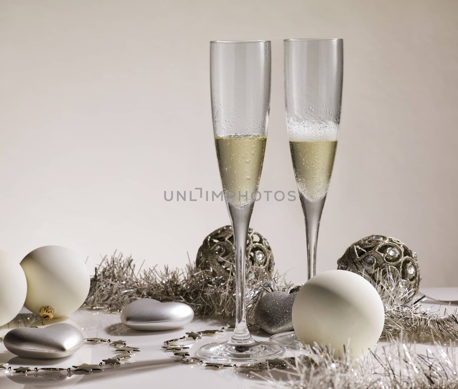 Pair of champagne glasses with silver ornaments and christmas balls