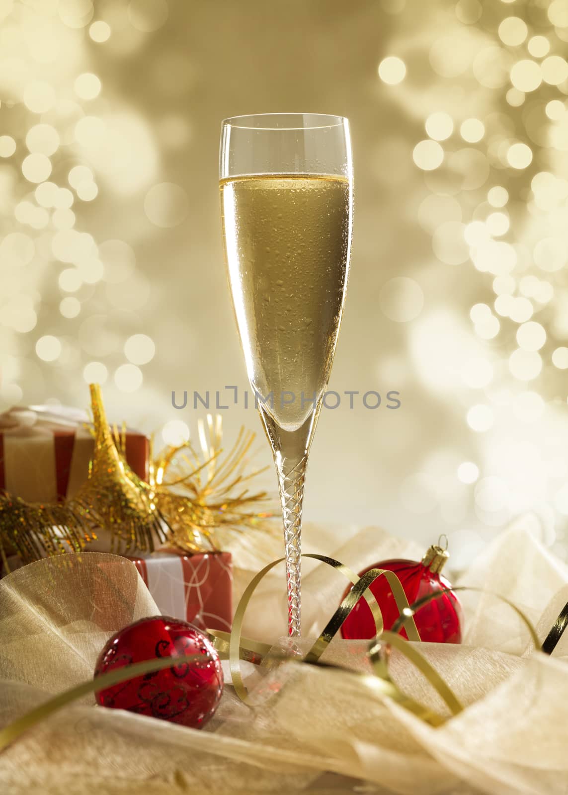 glass of champagne with lights in the background. very shallow depth of field. by janssenkruseproductions