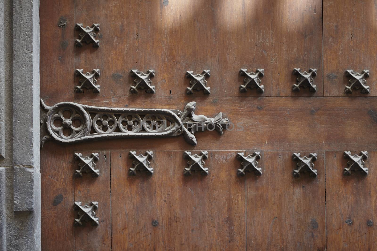 Old wooden door with metal hinges and lock
