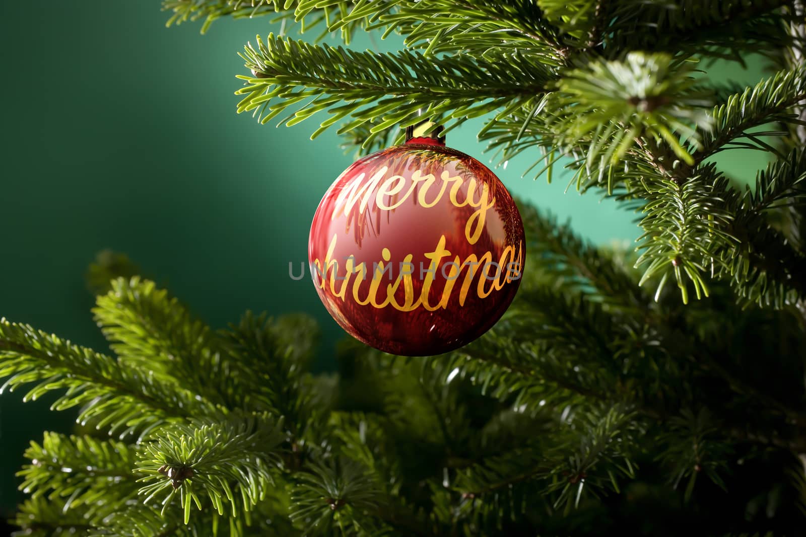 Christmas ball with the text merry christmas and green spruce branch on a green background
