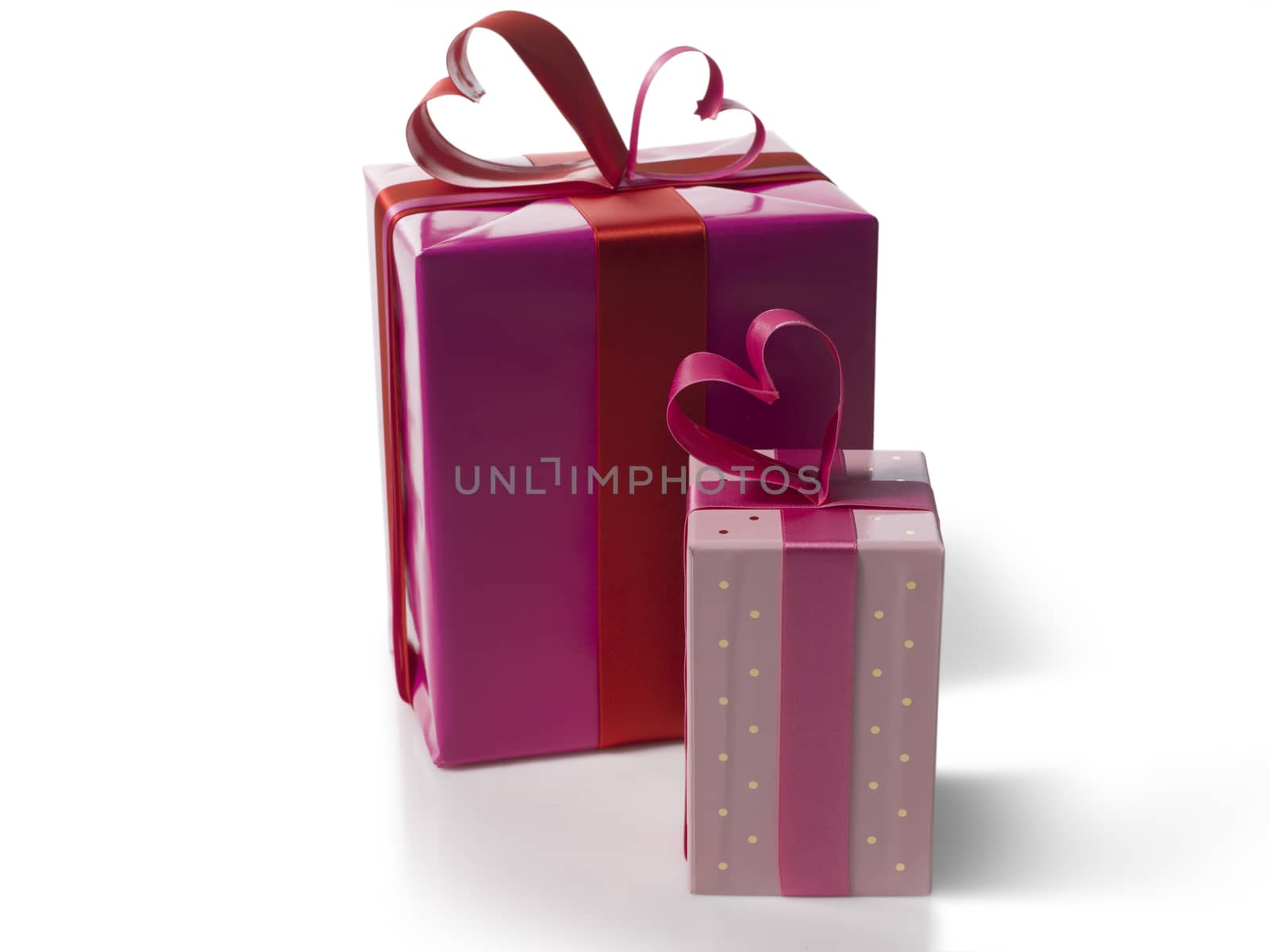 Set of pink gift boxes with a heart on a white background.
