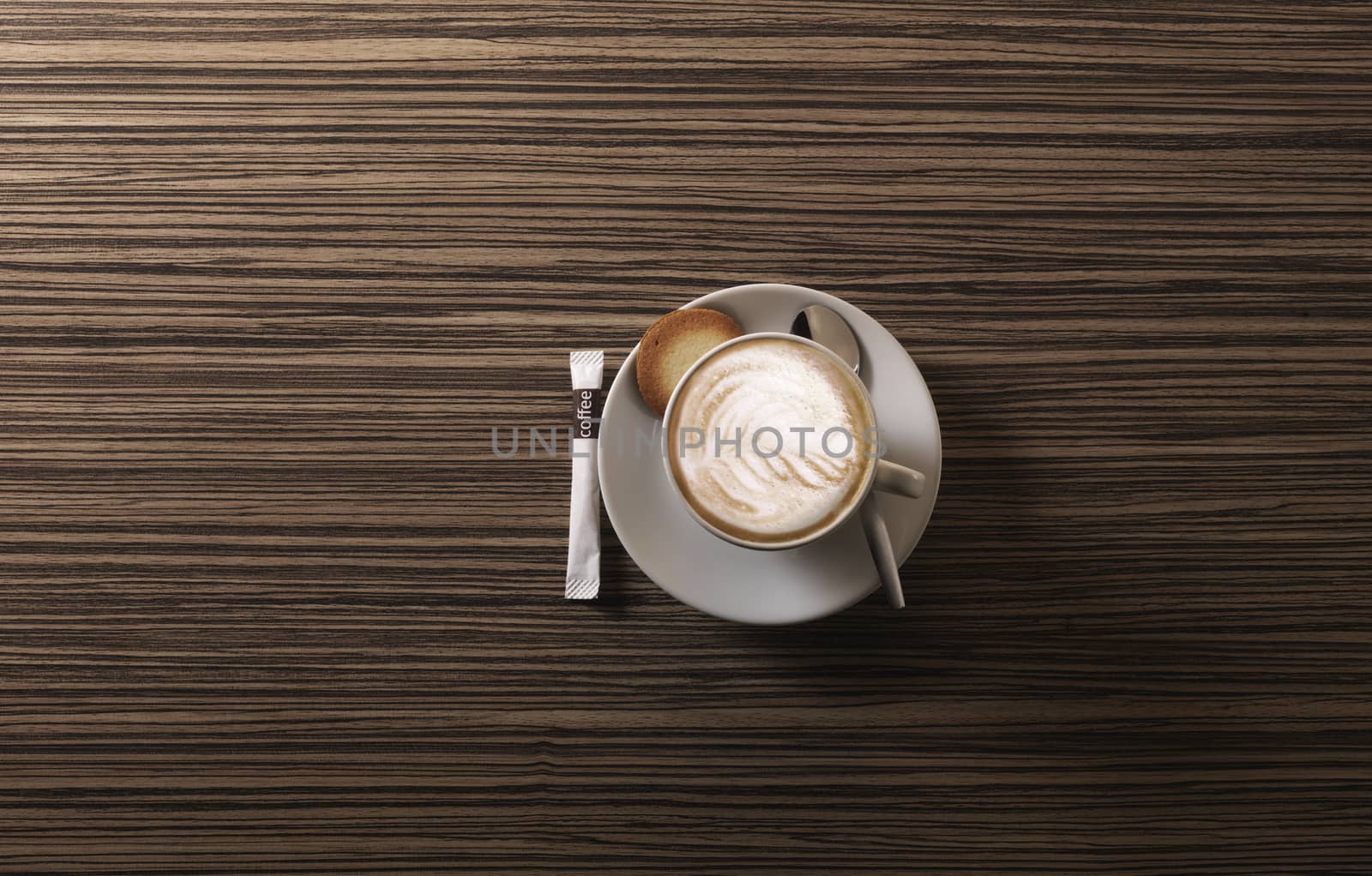 Cappuccino from above with spoon on a wooden background by janssenkruseproductions