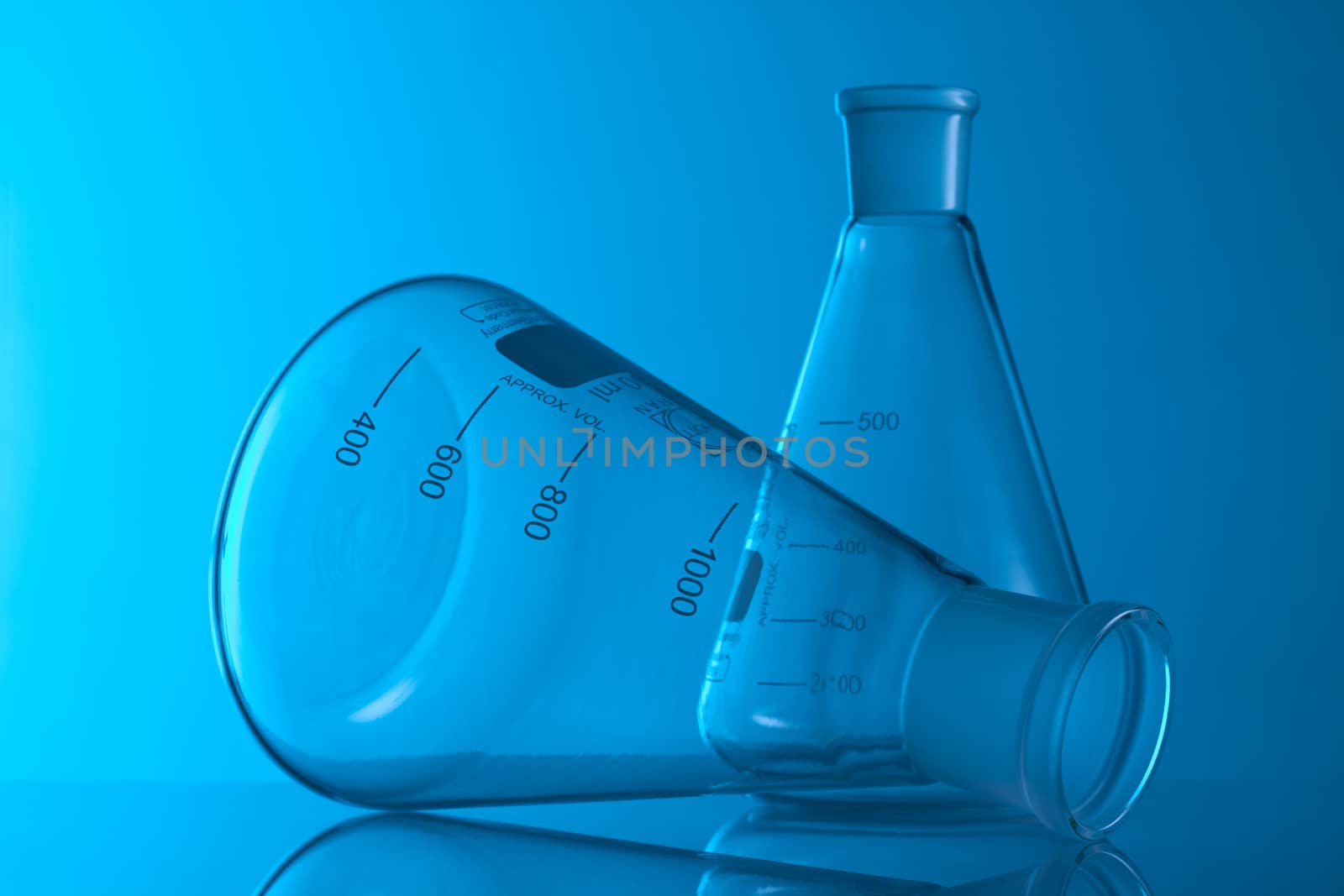 Laboratory Glassware in blue table in laboratory by janssenkruseproductions