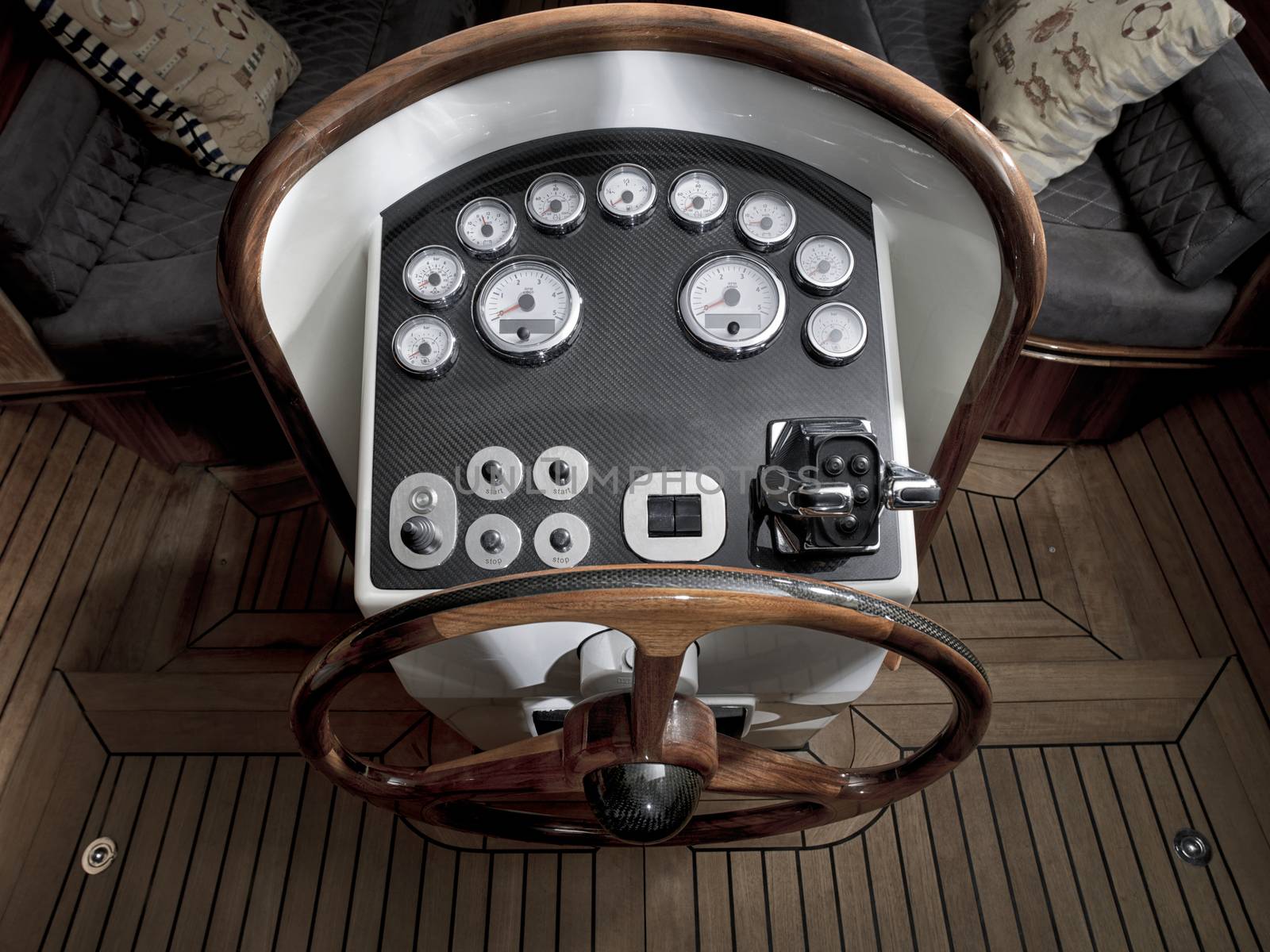 Vintage wooden boat with steering wheel and dashboard.