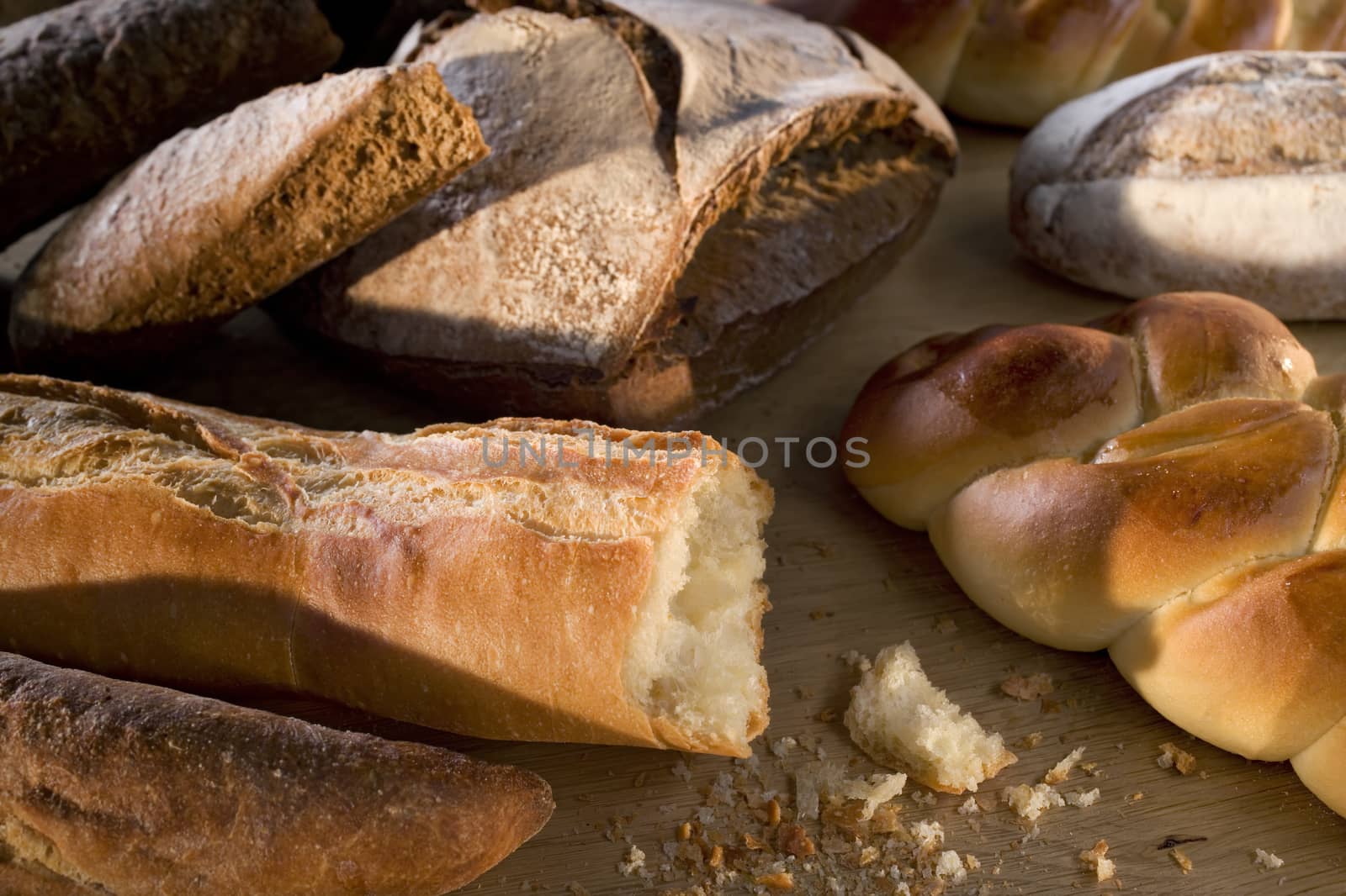 Delicious freshly baked bread on wooden background by janssenkruseproductions