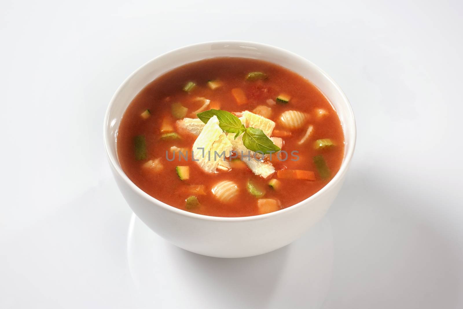Homemade delicious minestrone soup with cheese and basil