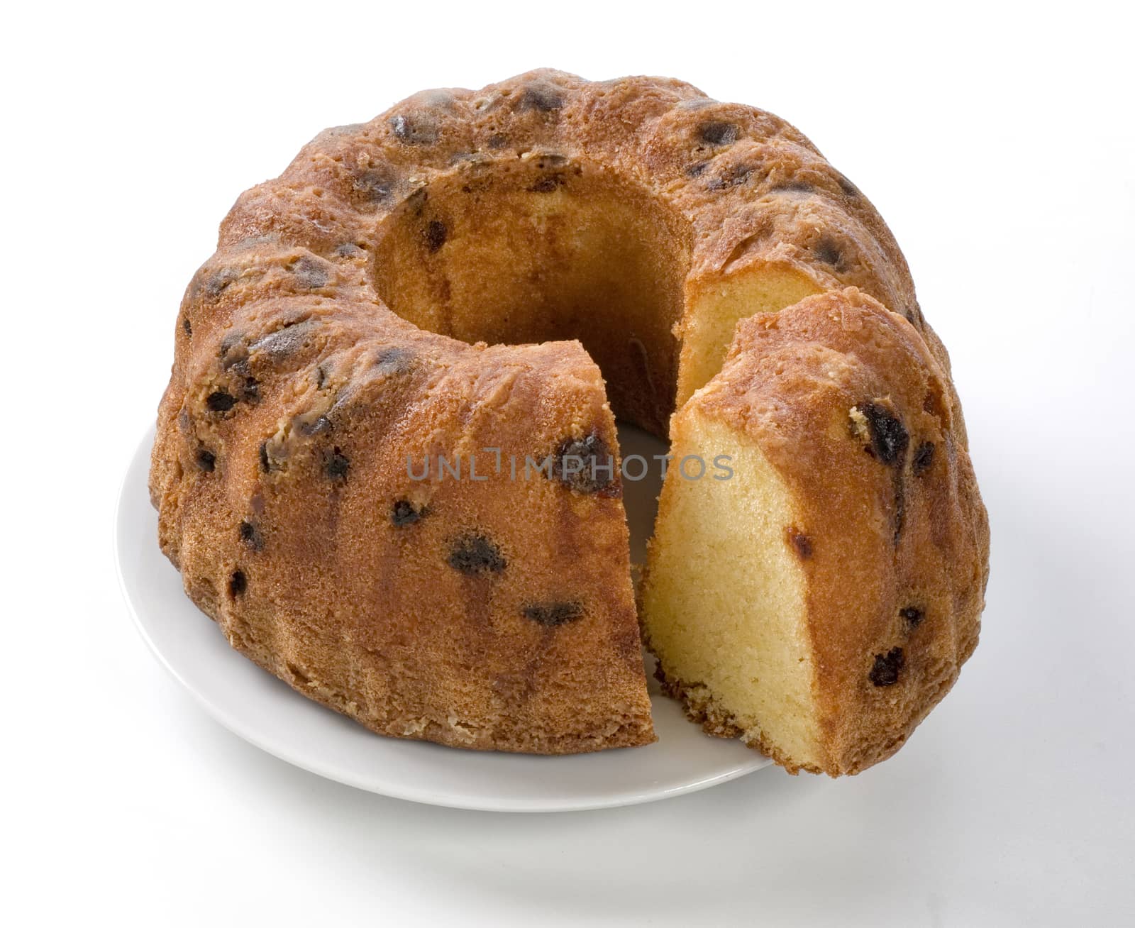 Sliced yellow Cake with raisins on a White Plate