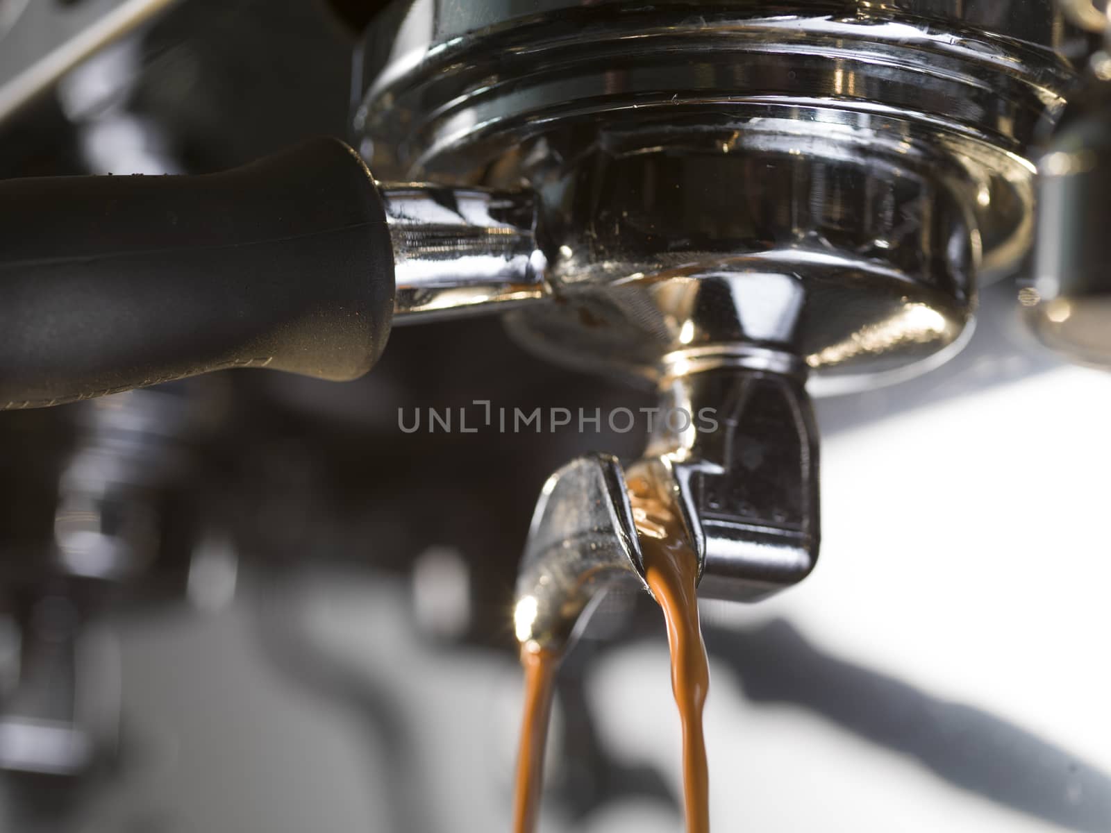 espresso extraction with a proffessional coffee machine, close up by janssenkruseproductions