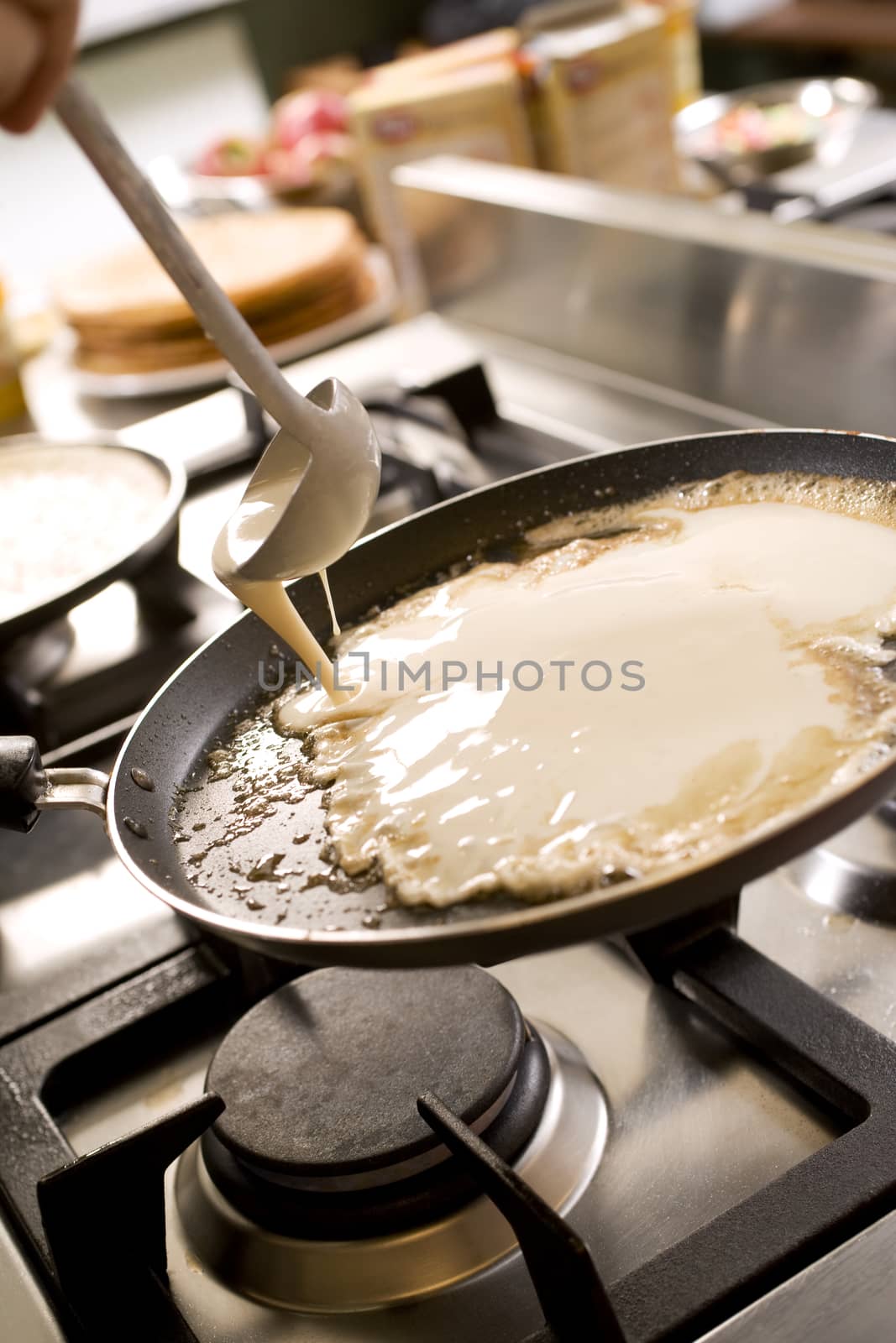 pancakes cooking on the hot stove griddle. Shallow depth of fiel by janssenkruseproductions