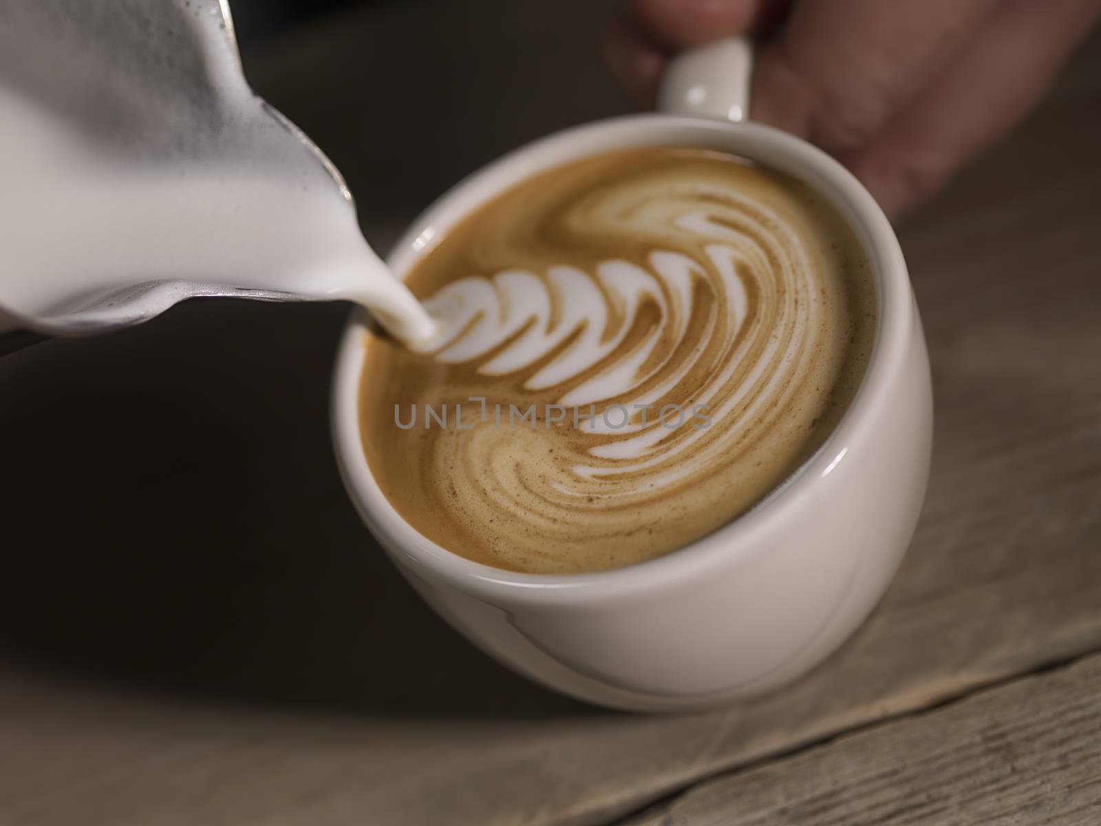 Cappucino in coffe cup with a can by janssenkruseproductions