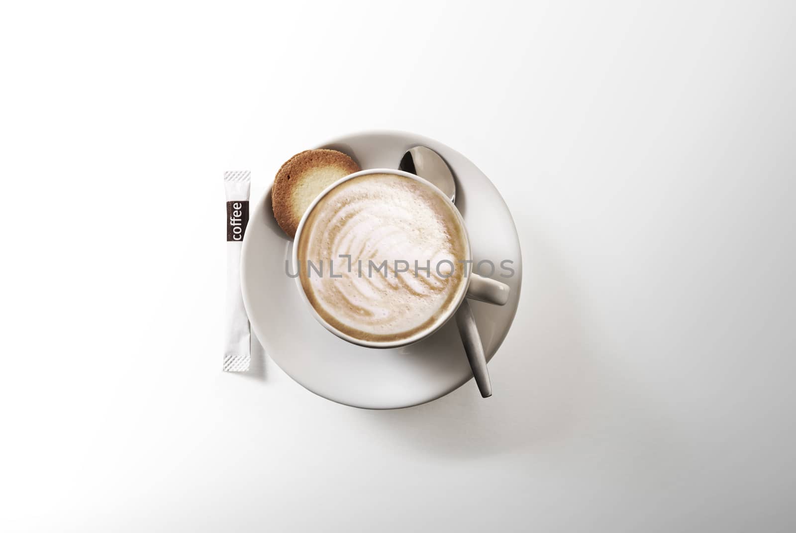 Cappuccino above with spoon. Isolated on white background.