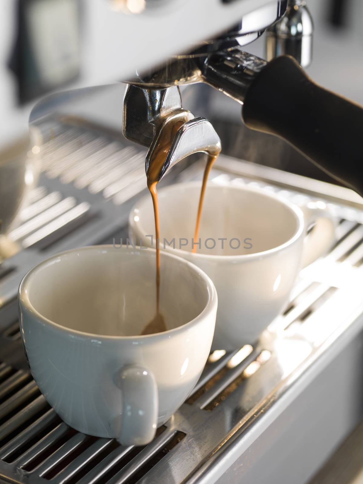 Espresso being made with a professional coffee machine. by janssenkruseproductions