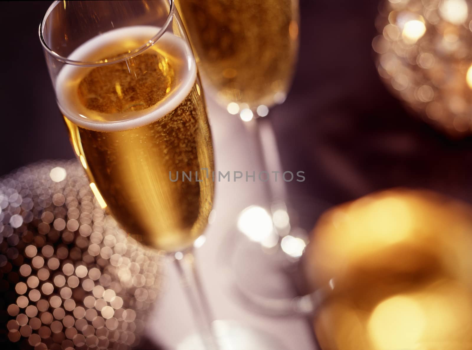 Two champagne glasses over christmas background with copy space