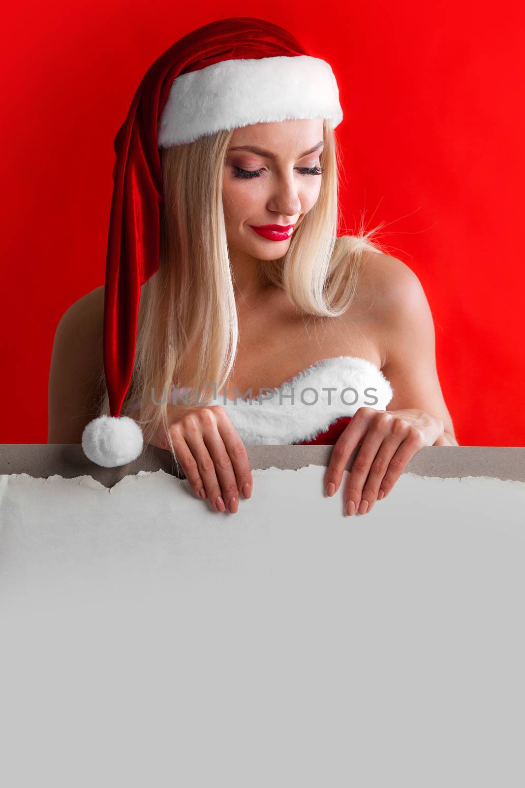 Sexy Santa woman posing with blank banner with copy space