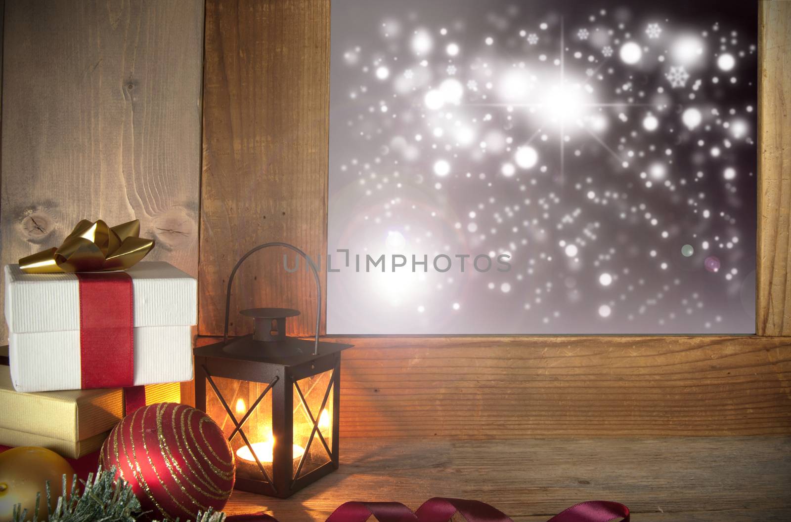 Christmas gifts next to a window with bokeh lights outside