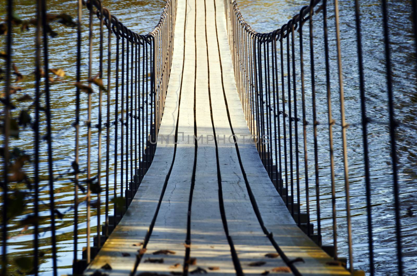 Wooden suspension bridge hanging over the river