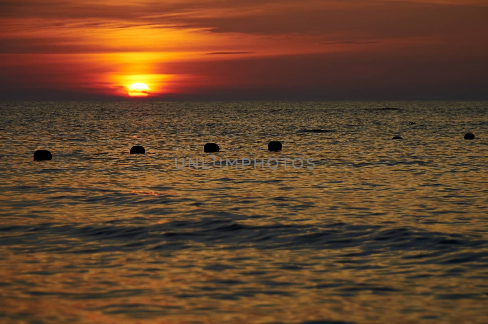 Fishing net in the sea at the sunset