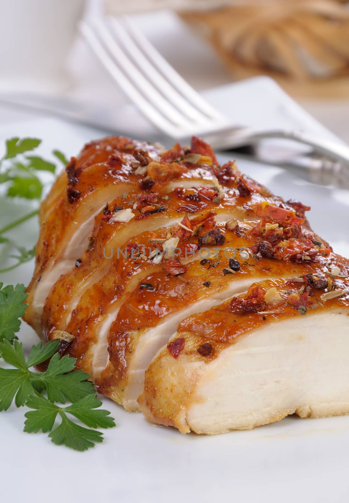 baked chicken breast sliced on a plate close-up