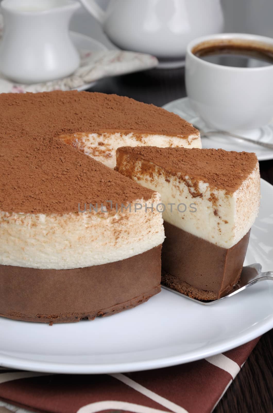 Cut a piece of chocolate with vanilla mousse cake covered  cocoa