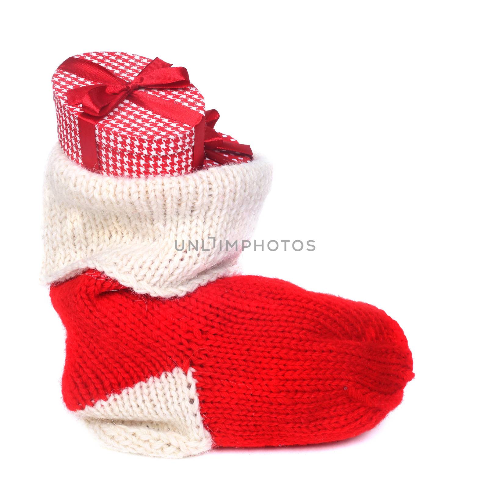 Red Christmas sock with gifts isolated on white background