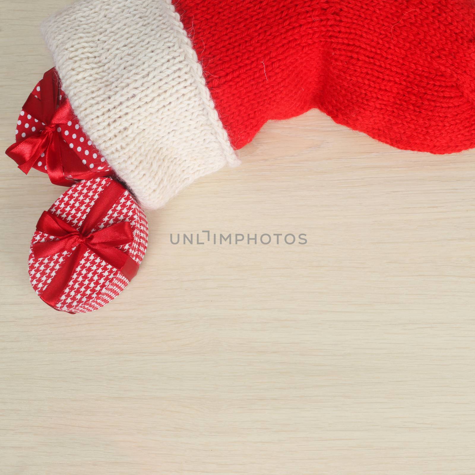 Red Christmas sock isolated on wooden background